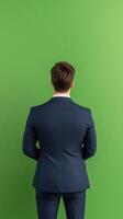 Professional Real Estate Agent in Suit Facing Green Screen Background for Digital Visual Content Production and Marketing photo