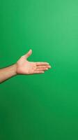 Hand Gesturing on Vibrant Green Screen Background for Magic Trick or Graphic Design Concept and Creative Presentations photo
