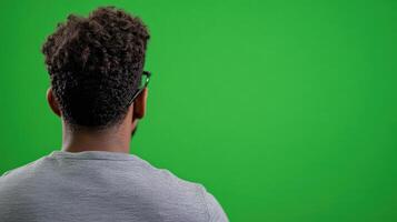 Man in Grey Shirt Facing Green Screen in Coding Workshop for Tech Design and Interactive Media Projects photo