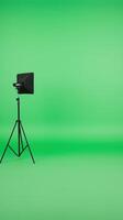 Green Screen Studio with Tripod and Teleprompter for Professional Production and News Broadcasting in Modern Media Environment and Creative Content Creation photo