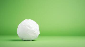 Stop Motion Paper Ball Unwrapping on Green Background Highlighting Creative Presentation and Eco Friendly Concept photo