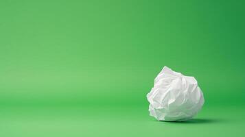 Stop Motion of Paper Ball on Green Background Showcasing Unwrapping Process with Minimalist Design for Creative Conceptual Art photo