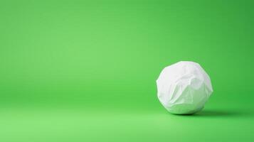 Stop Motion of Paper Ball Unwrapping on Green Background in Minimalist Style with Copy Space for Creative Projects and Eco Friendly Design Concepts photo
