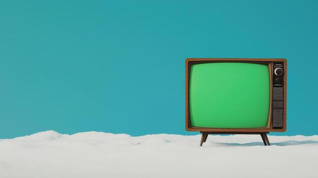 Retro Vintage Television with Glowing Green Screen Against Minimalist Sky Blue Background in Snowy Setting Perfect for Nostalgia Concept and Creative Design Projects photo