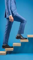 Blue-suited leg steps confidently onto ascending wooden blocks, symbolizing progress and achievement. Vertical Mobile Wallpaper photo