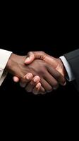 Two hands, dark-skinned and light-skinned, clasp firmly, symbolizing unity and collaboration. Vertical Mobile Wallpaper photo