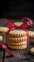 Cookies with Ribbon Buttery cookies stacked, tied with red ribbon on rustic wooden surface Vertical Mobile Wallpaper photo