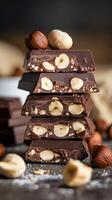 Hazelnut filled chocolate bars stacked on rustic surface Vertical Mobile Wallpaper photo