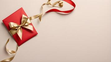 An empty red envelope with a gold ribbon is placed against a neutral-colored backdrop, leaving space for a greeting. photo