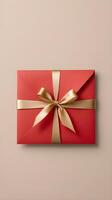 A plain red envelope with a gold ribbon is placed on a neutral-toned background, leaving space for a festive message. photo