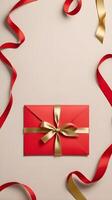 a simple, empty red envelope with a gold ribbon tied around it, placed on a neutral-colored background. The open space allows for a festive message. photo