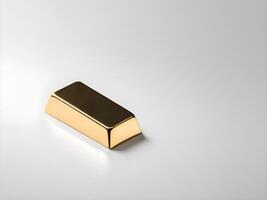 A gold ingot is gently placed on a plain white background, casting a faint shadow, with ample space for text. photo