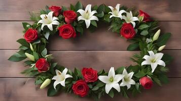 A beautifully arranged wreath of red roses, white lilies, and green leaves is placed on a wooden surface, with space in the middle perfect for a romantic message. photo