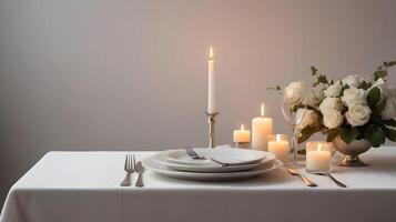 The elegant dinner setting, complete with silverware and lit candles on a white tablecloth, offers a warm, romantic ambiance, leaving space for a loving note. photo