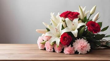 The soft lighting and gentle shadows on a bouquet of red roses, white lilies, and pink carnations on a wooden table bring a romantic ambiance, with ample space for text. photo