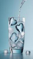 Heart-shaped ice cubes in a glass of sparkling water add a crisp, fresh vibe, with ample space in the clear glass for text. photo