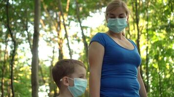 Mother and child in medical masks walk in the Park 03 video