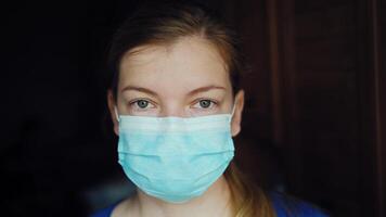 Happy smiling female scientist taking off protective medical face mask video