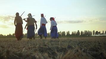 Group of Cossack men in traditional clothes swinging and spinning sharp shashkas 02 video