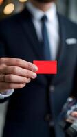 Man in suit holds vibrant red ticket, emphasizing its bold contrast Vertical Mobile Wallpaper photo