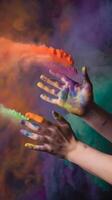 Hands smeared with colorful paint against multicolored cosmic background Vertical Mobile Wallpaper photo