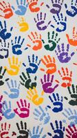Multicolored handprints scattered across a white surface, reflecting creativity and community Vertical Mobile Wallpaper photo