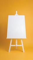Rectangular easel on vibrant yellow backdrop, emphasizing simplicity and creativity Vertical Mobile Wallpaper photo