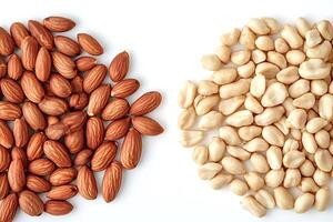 Almonds and peanuts forming two separate groups on white background photo