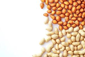 Peanuts with and without shell forming a border on white background photo