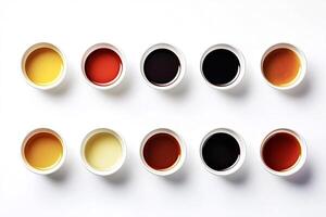 Ten small bowls containing different colorful liquids forming two rows photo