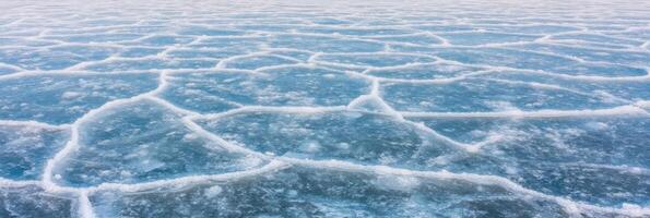Cracked ice texture on frozen lake surface exhibiting natural patterns photo