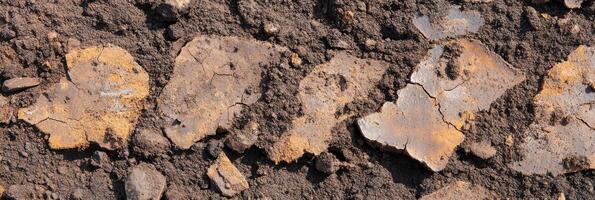 Cracked dry mud with earthy soil texture in natural environment concept photo