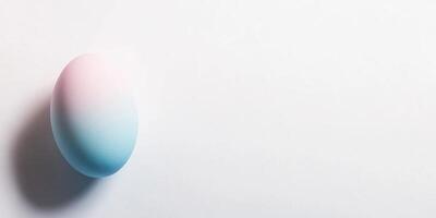 Pastel gradient egg on minimal white background for easter and spring themes photo