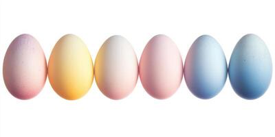 Colorful easter eggs in pastel tones arranged in a row on white background photo