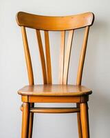 A Simple Wooden Chair Against A Neutral Background photo