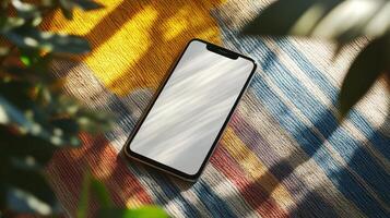 Smartphone Mockup on Colorful Tapestry Outdoors Sunlit Scene Summer Vibes photo