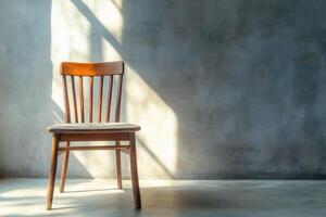 Wooden Chair Against A Textured Wall In Sunlight photo