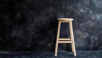 Simple Wooden Stool Against Dark Textured Wall photo