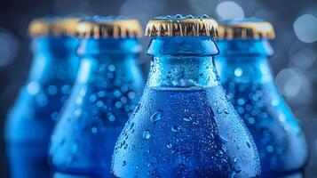 Blue glass soda bottles line up perfectly, displaying carbonated beverages with condensation drops, creating refreshing summer vibes against soft bokeh background. bottles photo