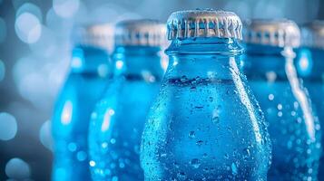 Blue glass soda bottles line up perfectly, displaying carbonated beverages with condensation drops, creating refreshing summer vibes against soft bokeh background. refreshing photo