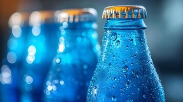 Blue glass soda bottles line up perfectly, displaying carbonated beverages with condensation drops, creating refreshing summer vibes against soft bokeh background. transparent photo