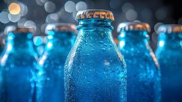 Blue glass soda bottles line up perfectly, displaying carbonated beverages with condensation drops, creating refreshing summer vibes against soft bokeh background. fizzy photo