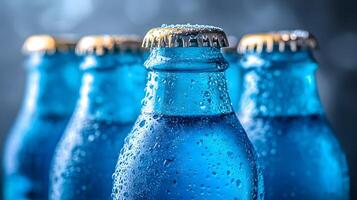 Blue glass soda bottles line up perfectly, displaying carbonated beverages with condensation drops, creating refreshing summer vibes against soft bokeh background. sparkle photo