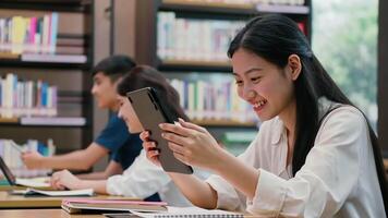 University students studying in library or Researching for an assignment in library video