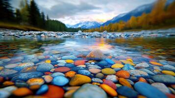Vibrant Colorful Stones in Crystal Clear River Water Mountain Sunset Background photo