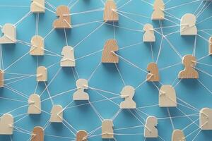 Wooden figures interconnected by strings forming a network photo