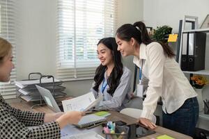 Business team collaborating and analyzing data in a modern office setting photo