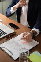 Senior financial analyst preparing report with charts and graphs in professional office setting photo