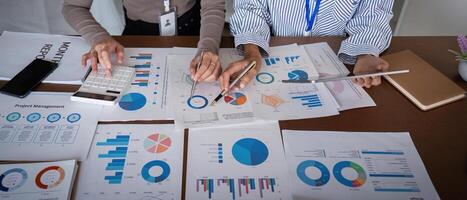 Business team analyzing project management charts and data in a modern office meeting photo