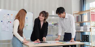Collaborative UX UI team discussing design sketches and strategies in a bright modern office environment photo